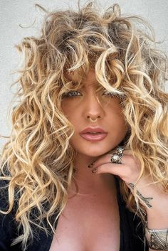 This hairstyle flaunts a cascade of lush, voluminous curls, exuding a sense of playfulness and depth. The highlights are expertly applied, accentuating the curls and adding dimension, while creating a radiant, sun-kissed effect. The shoulder-length cut offers a versatile look that's easy to manage and - Click to see more of Stunning Highlight Ideas for Curly Hair: 29 Natural Curls to Inspire Your Next Look and follow us for more hairstyle ideas. // Photo Credit: Instagram @haircofayetteville Waterfall Curls, Short Blonde Curly Hair, Curly Hair Highlights, Blond Hairstyle, Ideas For Curly Hair, Curly Highlights, Highlight Ideas, Blonde Curly Hair, Boring Hair