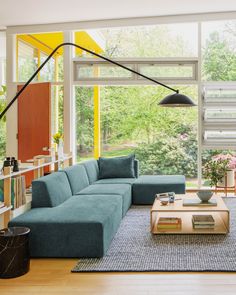 a living room filled with furniture and lots of windows