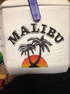 a cooler with palm trees and the word malubu painted on it's side