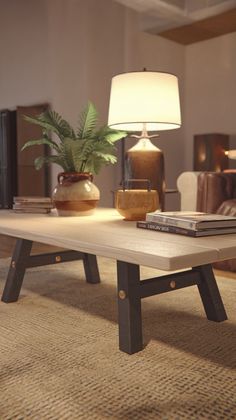 a coffee table sitting on top of a rug in a living room next to a lamp