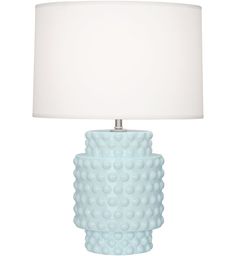 a white table lamp with a white shade on the base and a light bulb attached to it