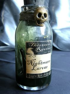 a bottle with a skull in it sitting on a table