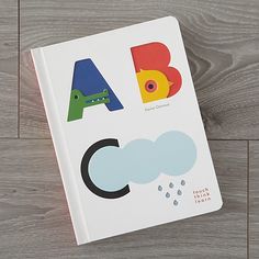 a children's book about abc and letter sounds on a wooden floor with the title abc