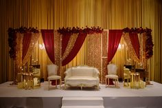 a white couch sitting on top of a table next to two chairs and a chair