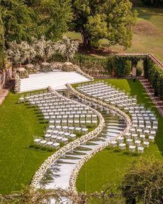 an aerial view of a wedding venue with rows of chairs set up for the ceremony