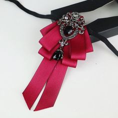 Elegant Wedding Lapel Pin With Ribbon, Elegant Ribbon Lapel Pin For Party, Elegant Rhinestone Brooch For Party, Elegant Red Pins For Party, Elegant Red Party Pins, Elegant Party Bow Tie Pins, Elegant Party Pins With Bow Tie Detail, Formal Dress Accessories, Wedding Formal Dress