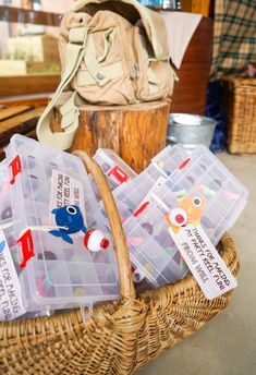 several plastic containers with magnets in them sitting on a wicker basket next to a purse