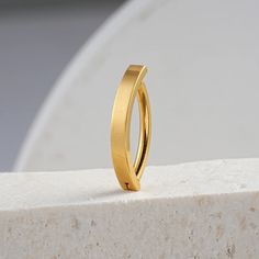 a gold ring sitting on top of a white block