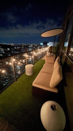 an outdoor lounge area overlooking the city at night