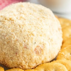 a close up of a doughnut on a plate with crackers next to it