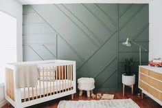 a baby's room with a crib and dresser