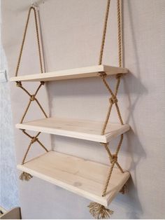 two wooden shelves with rope hanging from them