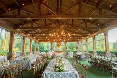 an outdoor venue with tables and chairs set up for a formal function in the evening