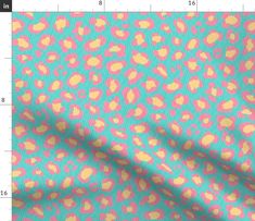 a pink and blue leopard print fabric with yellow spots on the top, in front of a ruler