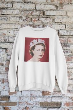 Retro Queen Elizabeth Sweatshirt. Ideal for any situation, a unisex heavy blend crewneck sweatshirt is pure comfort. These garments are made from polyester and cotton. This combination helps designs come out looking fresh and beautiful. The collar is ribbed knit, so it retains its shape even after washing. There are no itchy side seams on these sweaters. \n.: 50% cotton, 50% polyester\n.: Medium-heavy fabric (8.0 oz/yd² (271.25 g/mn.: Loose fit\n.: Sewn-in label\n.: Runs true to size Queen Elizabeth Ii Shirt, Yellow T Shirt, Queen Elizabeth, Sew-in Labels, The Queen, Heavy Fabric, Crewneck Sweatshirt, Sweat Shirt, Ribbed Knit