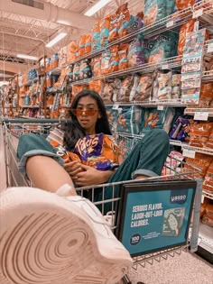 a woman sitting in a shopping cart with her legs crossed