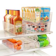 an open refrigerator door with food and drinks on the bottom shelf, including orange juice