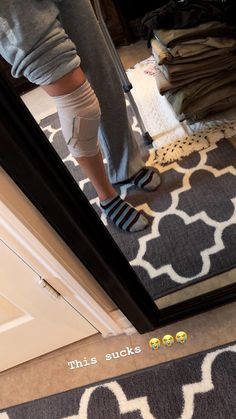 a person standing in front of a mirror with socks on