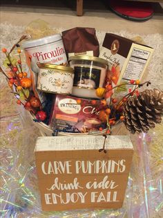 a basket filled with lots of different types of food and decorations on top of a table