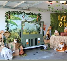 an animal themed birthday party with jungle animals and decorations on the walls, including fake giraffes