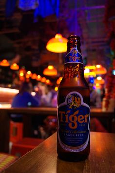 a beer bottle sitting on top of a wooden table