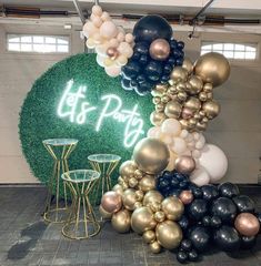 balloons and tables in front of a sign that says it's party