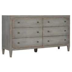 an old gray dresser with wooden drawers