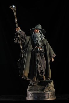 a statue of an old wizard holding a staff