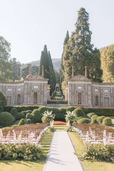 an outdoor ceremony setup in the middle of a garden with rows of chairs and trees