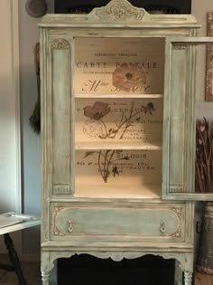 an old china cabinet with flowers painted on it