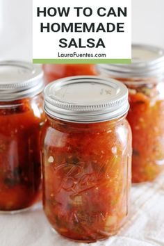 four jars filled with homemade salsa sitting on top of a white table cloth and text overlay reads how to can homemade salsa