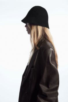 Modern, directional accessories have always been a key part of the COS womenswear collections. This bucket hat is knitted with wide, ribbed wales that will add texture to otherwise minimal outfits. It's offered in a mocha-brown hue and crafted from a soft RWS wool blend with cotton for breathability.  This product is Responsible Wool Standard (RWS) certified by Control Union 893290 and contains wool fibre from farms certified to animal welfare and land-management requirements Shell: 55% RWS Wool Wool Bucket Hat Outfit, Knit Bucket Hat, Wool Bucket Hat, Bucket Hat Outfit, Bucket Hat Women, Land Management, Minimal Outfit, Mocha Brown, Outfits With Hats