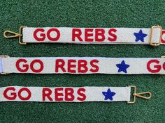 The perfect way to rep your school against opposing teams at football games or every day around campus! Our new and improved adjustable beaded bag strap has finally launched! Gently slide the buckle to customize the strap to the length of your choosing The GO REBS strap is made of blue, white and red glass beads hand sewn bead by bead with an added paw print pattern and attached to a matching white fabric. -Beaded Strap has a width of 1 1/2 inches.  -At full length the bag strap is 4 feet long w Ole Miss Game Day, Paw Print Pattern, Hotty Toddy, Beaded Strap, Beaded Bag, Ole Miss, Purse Strap, Hook Clasp, Day Bag