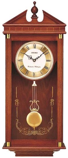 a wooden clock with roman numerals on the front and sides, in an ornate frame