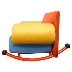 an orange, blue and yellow rocking chair with wheels on the bottom is shown in front of a white background