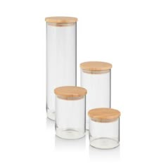 three clear jars with wooden lids