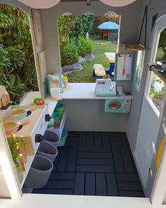 the inside of a child's play house with toys and accessories on the counter