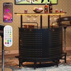 an entertainment center with a bar, stools and a phone on the wall next to it