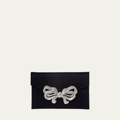 Judith Leiber Couture satin clutch bag with crystal-embellished bow accent. Detachable shoulder strap, 18.9" drop. Envelope flap with snap closure. Interior, satin lining; one slip pocket. 5"H x 8.5"W x 0.5"D. Imported. Elegant Bag With Detachable Bow As Gift, Elegant Bag With Detachable Bow For Gift, Elegant Party Bag With Satin Bow, Elegant Party Bags With Satin Bow, Elegant Evening Bags With Satin Bow, Elegant Evening Bag With Satin Bow, Designer Clutch Evening Bag For Gala, Designer Envelope Bag For Formal Occasions, Formal Envelope Bag With Dust Bag Included