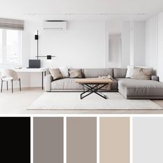 a living room filled with furniture and lots of neutral colors on the walls, along with a coffee table