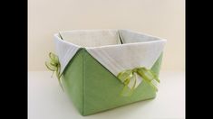 a green and white basket sitting on top of a table