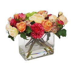 a vase filled with lots of different colored flowers