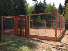 a large wooden fenced in area next to trees