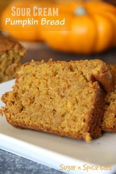 two pieces of pumpkin bread on a white plate