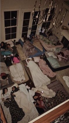 a room filled with lots of clothes on top of a floor next to a window