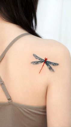 a woman with a dragon tattoo on her shoulder