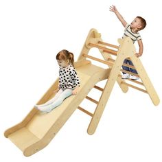 two children playing on a wooden slide