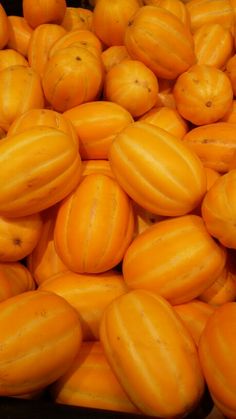 a pile of yellow gourds sitting next to each other