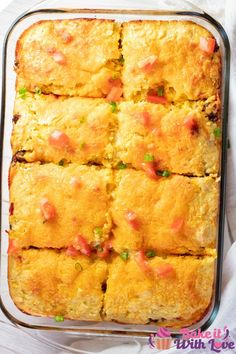 a casserole dish filled with meat and vegetables on top of a white cloth