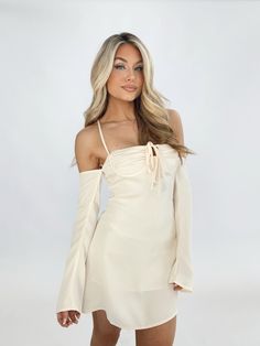 Indulge in luxury with our Della Mini Dress. The smooth satin fabric and soft inner lining provide ultimate comfort, while the front tie detail and bustier design offer a chic, elevated look. Thin straps, off the shoulder long sleeves, and a lace-up back add a touch of trendiness. Perfect for date nights, dinner, drinks, or even a vacation. Embrace the carefree vibes of spring and summer with this elegant and sophisticated dress. Self 97% Polyester 3% Spandex Lining 100% Polyester Hand wash cold Dinner Drinks, Sophisticated Dress, Date Nights, Satin Fabric, Date Night, Off The Shoulder, Hand Wash, Lace Up, Long Sleeves